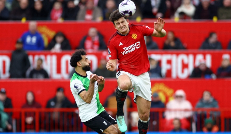 Liverpool's Mohamed Salah in action with Manchester United's Harry Maguire | Reuters